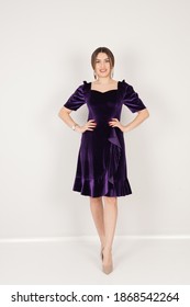 Portrait Of Woman In Dark Purple Dress In Studio