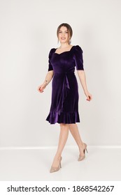 Portrait Of Woman In Dark Purple Dress In Studio