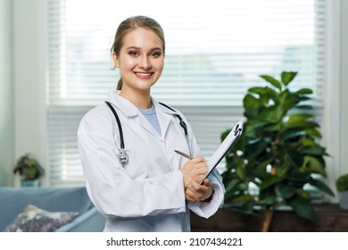 Portrait Of A Woman Doctor With Stetoscope Looking At Camera. Smiling Female Doctor In A Clinic Background.