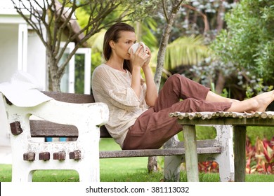 Portrait Of A Woman Drinking Tea Outside In Backyard