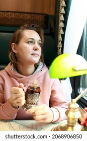 Portrait Of Woman Drinking Tea In Train Compartment