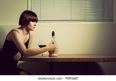 A Portrait Of A Woman Drinking Wine Alone By Candlelight.