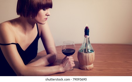 A Portrait Of A Woman Drinking Wine Alone By Candlelight.