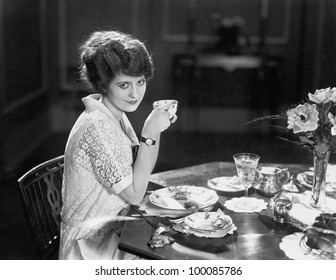 Portrait of woman eating meal at table
