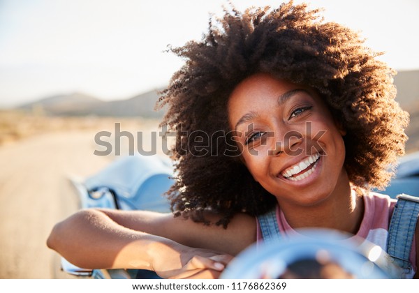 Portrait Of Woman Enjoying Road Trip In Open Top\
Classic Car