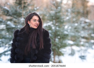 Portrait Of A Woman In Eyeglasses And Coat In A Cold Winter Forest