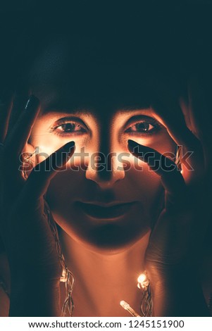 Abstract portrait of a young woman looking at camera