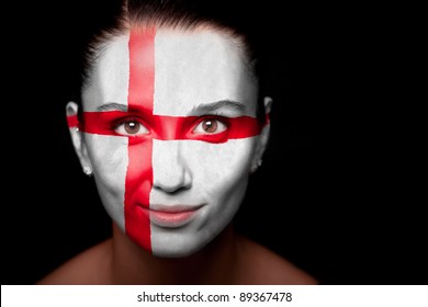 Portrait of a woman with the flag of the England painted on her face.