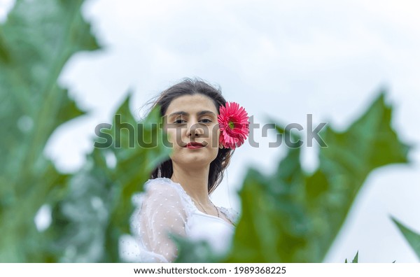 portrait of a woman with flower, portrait of a
pretty woman in the
garden