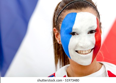 Portrait Of A Woman With The French Flag Painted On Her Face