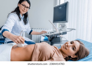 Portrait of woman getting ultrasound from doctor. Gastritis and digestion problems prevention. Pregnancy ovulation female health gynecologist health checkup - Powered by Shutterstock