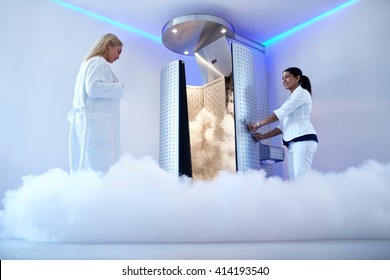 Portrait of woman going for cryotherapy treatment in cryosauna booth.