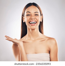 Portrait, woman and hand for beauty, skincare or advertising offer, space or mockup for marketing on white background in studio. Makeup, deal and smile on face for choice, cosmetics or palm for logo - Powered by Shutterstock