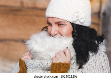 Portrait Of A Woman Hidden Behind Her Scarf. Close Up Portrait Of Happy Woman Wrapped In A Scarf With Faux Fur Trim, Sunny Winter Day