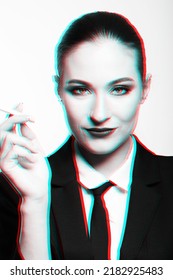 Portrait Of Woman Holding Cigarette In Her Hands And Looking To Camera. Model With Conservative Hairstyle And Wearing Classic Suit With Tie And White Shirt. Red And Blue Color Separation Effect