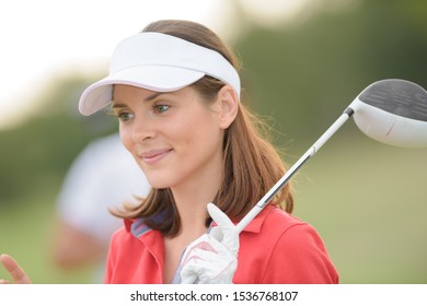 Portrait of woman holding golf club - Powered by Shutterstock