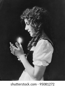 Portrait Of Woman Holding Lit Candle