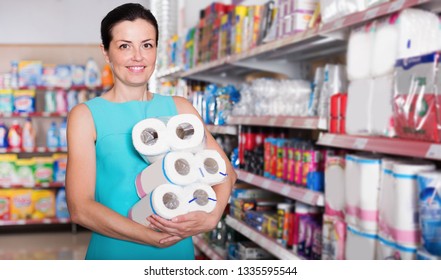 Portrait Woman Holding Pack Of Toilet Paper At The Modern Supermarket
