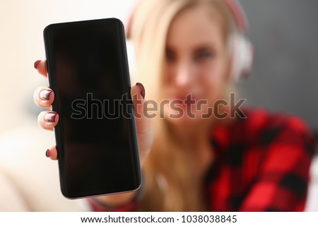 Portrait of a woman at home in headphones