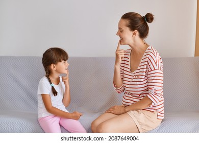 Portrait Of Woman And Little Girl Having Lesson For Improving Sounds Or Language Difficulties, Female Child Sitting Indoor On Comfortable Sofa And Practicing Articulation.