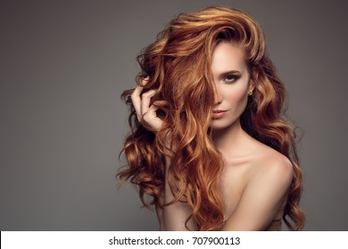 Portrait of woman with long curly beautiful ginger hair. 