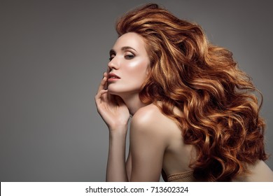 Portrait Of Woman With Long Curly Beautiful Ginger Hair. 