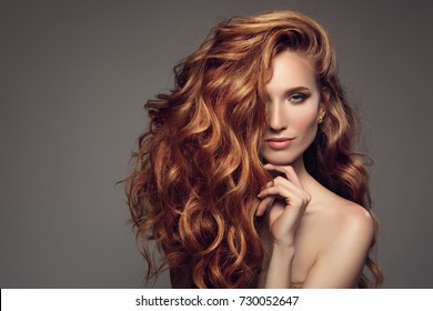 Portrait of woman with long curly beautiful ginger hair. 
