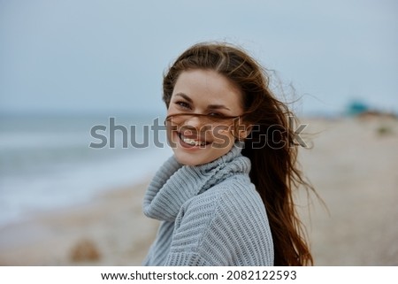 portrait of a woman with long hair on the beach nature landscape walk unaltered