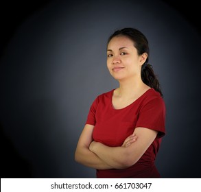 Portrait of woman looking at camera, studio shot, plain background. asian, long hair, adult
