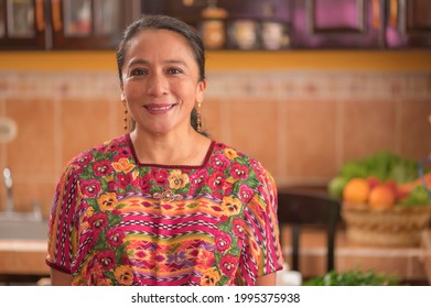 Portrait Of A Woman Looking At The Camera, Wearing A Colorful Blouse From The Region.