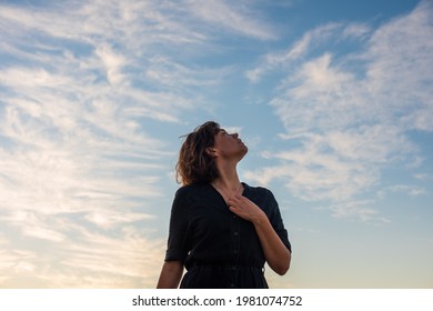 Portrait of woman looking up to the sky - Shutterstock ID 1981074752