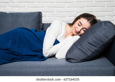 Portrait of woman lying on sofa and slipping. Casual style indoor shoot.