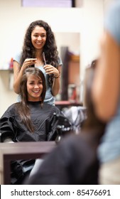 Portrait of a woman making a haircut standing up
