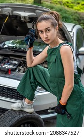 Portrait Of Woman Mechanic Near Broken Down Car On The Road Side. Service