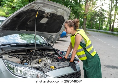 Portrait Of Woman Mechanic Near Broken Down Car On The Road Side. Service