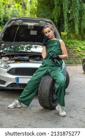 Portrait Of Woman Mechanic Near Broken Down Car On The Road Side. Service