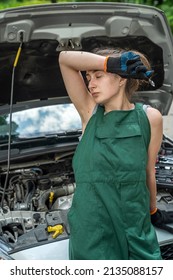 Portrait Of Woman Mechanic Near Broken Down Car On The Road Side. Service