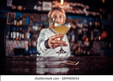 Portrait Of Woman Mixologist Formulates A Cocktail At The Bar Counter