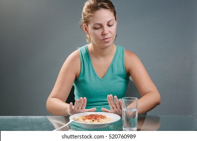 Portrait Of Woman With No Appetite In Front Of The Meal. Concept Of Loss Of Appetite