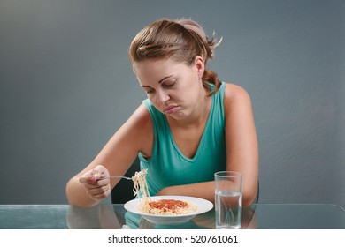 Portrait Of Woman With No Appetite In Front Of The Meal. Concept Of Loss Of Appetite