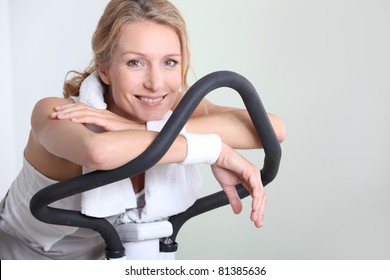 Portrait Of A Woman On Exercise Bike