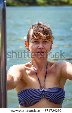 Portrait of woman at open air pool background