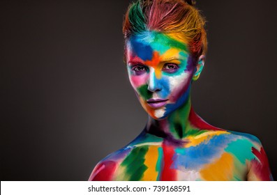 Portrait Of A Woman With A Painted Face. Creative Makeup And Bright Style.