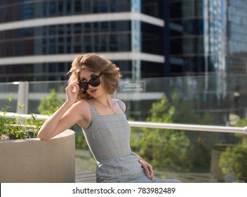 Portrait Woman Peeking Over Sunglasses