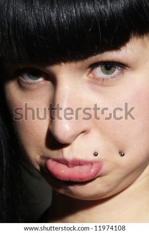 portrait of a woman with piercing and pout