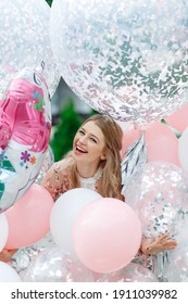 Portrait Of A Woman In A Pile Of Giant Balloons.