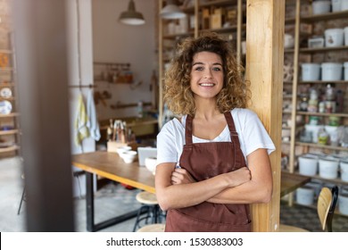 Portrait of woman pottery artist in art studio - Powered by Shutterstock