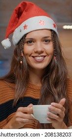 Portrait Of Woman Pouring Coffee In Festive Kitchen Decorated For Christmas Celebration. Cheerful Young Adult Smiling While Preparing Winter Holiday Beverage In December At Home