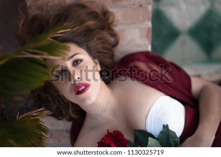 Portrait of woman in with red flower