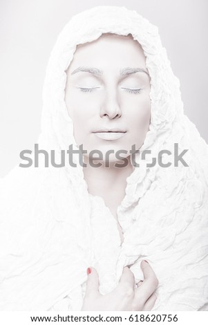 Portrait of a woman with sallow pale face in white scarf